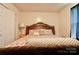 Main bedroom with wooden bed frame and neutral decor at 831 College Ave, Shelby, NC 28152
