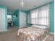 Spacious bedroom with teal walls, carpeted floors, and a large window at 864 Stallion Spirit Trl, Clover, SC 29710