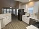 Modern kitchen with stainless steel appliances and white cabinets at 10021 Barbee Dr, Charlotte, NC 28269