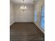 Formal dining room with wainscoting, hardwood floors, and chandelier at 10021 Barbee Dr, Charlotte, NC 28269