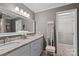 Bathroom with double vanity, granite countertop, and large mirror at 1400 Fern Forest Dr, Gastonia, NC 28054