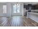 Bright dining room with hardwood floors and chandelier, adjacent to kitchen at 2204 Noble Townes Way, Charlotte, NC 28262