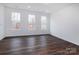 Bright bonus room with hardwood floors and three windows at 2208 Noble Townes Way, Charlotte, NC 28262