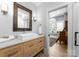 Modern bathroom with a white sink, light wood cabinets, and view into room at 16500 Green Dolphin Ln, Cornelius, NC 28031