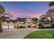 Elegant two-story home with a welcoming front porch and meticulous landscaping at 16500 Green Dolphin Ln, Cornelius, NC 28031