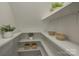 Shelves in a pantry with decorative bowls and plants at 4614 Halstead Dr, Charlotte, NC 28209