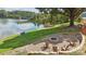 Lakefront fire pit area with Adirondack chairs and a scenic view at 7109 Brookview Ln, Sherrills Ford, NC 28673