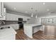 Open kitchen with white cabinets, island, and views into adjacent living area at 7109 Brookview Ln, Sherrills Ford, NC 28673