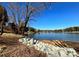 Lakefront view with rocky shoreline and trees at 7117 Brookview Ln, Sherrills Ford, NC 28673