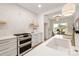 Modern kitchen with white cabinets, double oven, and gold faucet at 15906 Youngblood Rd, Charlotte, NC 28278