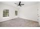 Spacious bedroom with two windows, carpet flooring, and ceiling fan at 15906 Youngblood Rd, Charlotte, NC 28278