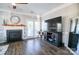 Living room with fireplace, large TV, and access to the balcony at 201 Langhorne Dr, Mount Holly, NC 28120