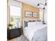 Serene bedroom with wood accent wall and ample natural light at 2051 Clarksdale Dr # 29, Charlotte, NC 28206
