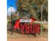 Vibrant red arrow sign with VBGB lettering, near park at 2051 Clarksdale Dr # 29, Charlotte, NC 28206
