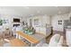 Open dining room with wooden table and bench seating near kitchen at 2565 Blue Sky Meadows Dr, Monroe, NC 28110