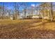 Home with screened porch and multiple storage sheds in a wooded setting at 2929 Matoka Trl, Matthews, NC 28104