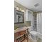 Bathroom with brown vanity, white toilet, and shower/tub combo at 2929 Matoka Trl, Matthews, NC 28104