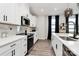 Modern kitchen features white cabinets, quartz countertops, and stainless steel appliances at 303 Grove Gate Ln, Indian Trail, NC 28079