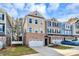Three-story townhome with neutral exterior and a two-car garage at 303 Grove Gate Ln, Indian Trail, NC 28079