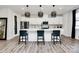 Modern kitchen with white cabinets, island, and stainless steel appliances at 303 Grove Gate Ln, Indian Trail, NC 28079