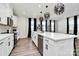 Modern kitchen with white cabinets, large island, and stainless steel appliances at 303 Grove Gate Ln, Indian Trail, NC 28079