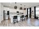 Modern kitchen with white cabinets, island, and stainless steel appliances at 303 Grove Gate Ln, Indian Trail, NC 28079