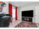 Functional bedroom with a desk, TV and red curtains at 303 Grove Gate Ln, Indian Trail, NC 28079