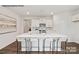 Bright kitchen featuring white cabinetry, an island with seating, and hardwood floors at 8039 Plymouth Dr, Sherrills Ford, NC 28673