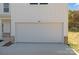 White two-car garage with brick accents at 1010 Kenton Pl, Salisbury, NC 28146