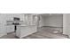 Open concept kitchen and dining area with island and grey wood-look floors at 1403 Gentry Pl, Salisbury, NC 28146