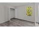 Well-lit bedroom, featuring wood-look floors and a closet at 1403 Gentry Pl, Salisbury, NC 28146