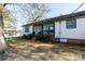 Side view of newly renovated home with white siding and black trim at 1554 Lynwood Dr, Lancaster, SC 29720