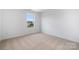 Well-lit bedroom featuring neutral wall-to-wall carpet at 2568 Blue Sky Meadows Dr, Monroe, NC 28110