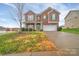 Brick two-story house with a green door and attached garage at 5146 Elementary View Dr, Charlotte, NC 28269