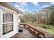 Wooden deck overlooking backyard with trees and partial fence at 108 Leslie Dr, Shelby, NC 28152