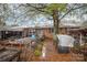 Backyard with multiple chicken coops and a large tree at 108 Leslie Dr, Shelby, NC 28152