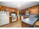 Kitchen with wood cabinets, tile floor, and white appliances at 108 Leslie Dr, Shelby, NC 28152