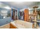Bathroom with jacuzzi tub, mirrored walls, and built-in shelving at 108 Leslie Dr, Shelby, NC 28152