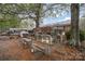 Backyard with multiple chicken coops and a large tree at 108 Leslie Dr, Shelby, NC 28152