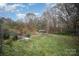 Large backyard with overgrown grass and a metal container at 108 Leslie Dr, Shelby, NC 28152