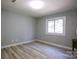 Simple bedroom with light gray walls and wood-look floors at 3995 Burton Ln, Denver, NC 28037