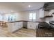 Modern kitchen with white cabinets, stainless steel appliances and dark countertop at 3995 Burton Ln, Denver, NC 28037