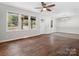 Spacious living room features hardwood floors, a ceiling fan, and abundant natural light at 4931 Mccormick Rd, Great Falls, SC 29055