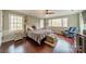 Cozy bedroom with hardwood floors, a ceiling fan, and ample window light at 9201 Doe Ct, Charlotte, NC 28277