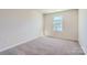 Simple bedroom with grey carpet and window at 9740 Inkberry Dr, Gastonia, NC 28056