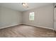 Well-lit bedroom showcasing wood-look floors and a window at 1211 Soulsville St, Rock Hill, SC 29732