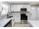 Updated kitchen with white cabinets, quartz countertops, and black faucet at 3728 Woodleaf Rd, Charlotte, NC 28205