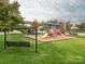 playground with swings and play structures at 591 Gatsby Nw Pl, Concord, NC 28027