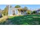 Charming bungalow with a covered porch and well-maintained lawn at 710 W Elm St, Shelby, NC 28150