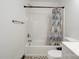 Clean bathroom with a shower/tub combo and patterned floor at 710 W Elm St, Shelby, NC 28150